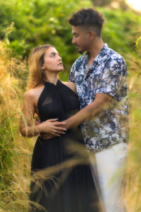 young couple hugging in the bushes