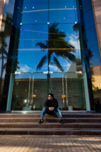 man sitting outside his apartment building.